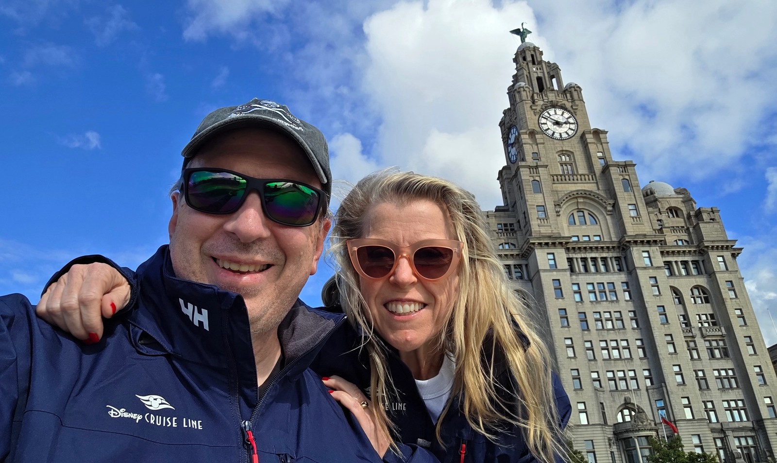 Guests smiling in front of the Royal Liver Building